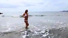 Dionne Daniels strips on the beach